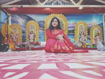 Smiling young woman sitting in temple