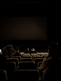 Rear view of people looking at camera