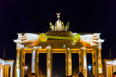 Statue of illuminated building at night