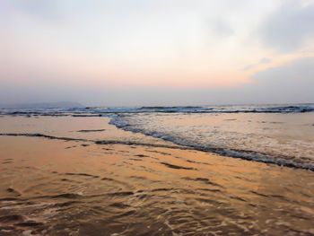 Scenic view of beach against sky during sunset