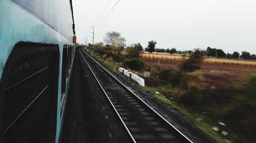 Railroad tracks seen through train windshield