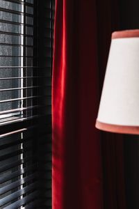 Red curtain by window in darkroom