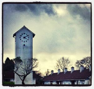 Low angle view of building against cloudy sky