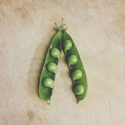 Directly above shot of green peas on table