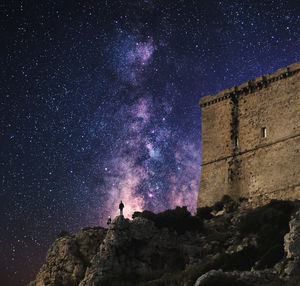 Low angle view of building against star field