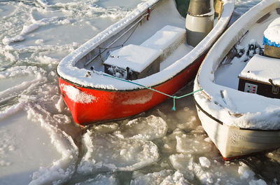 High angle view of boats moored on frozen sea