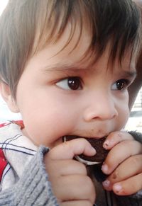 Close-up portrait of cute boy holding girl