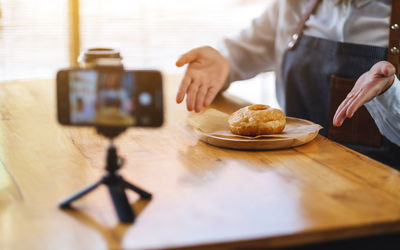 Midsection of man preparing food on table