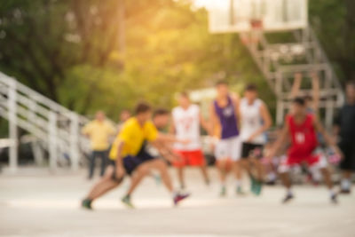 Group of people running on road