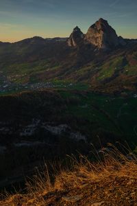 Scenic view of land and mountains against sky