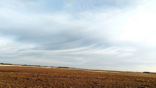 Scenic view of landscape against cloudy sky