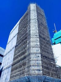 Low angle view of modern building against clear blue sky