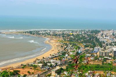 High angle view of cityscape by sea against sky