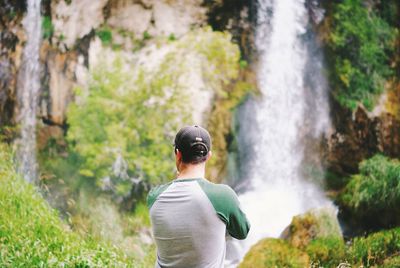 Woman standing on rock in forest