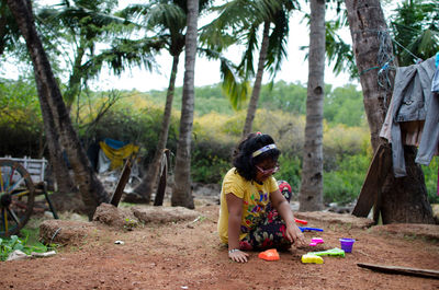 Boy sitting on tree