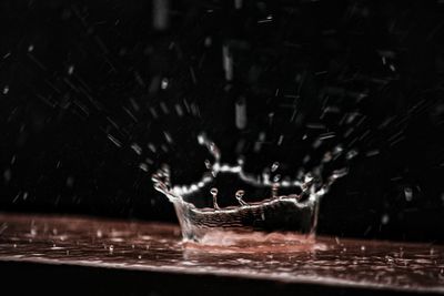 Close-up of water splashing against black background