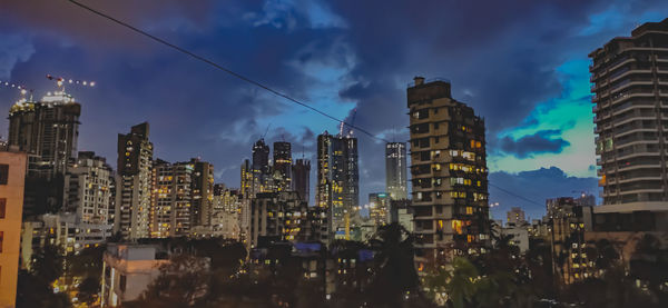 Panoramic view of buildings in city against sky