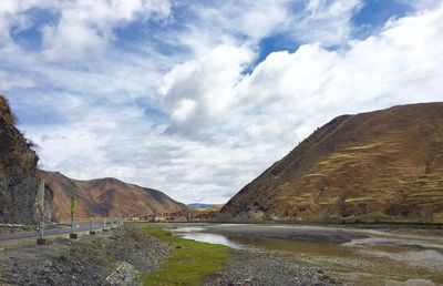 Scenic view of mountains against cloudy sky