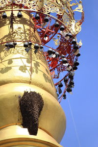 Low angle view of carousel against clear sky