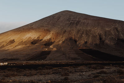 View of arid landscape against clear sky