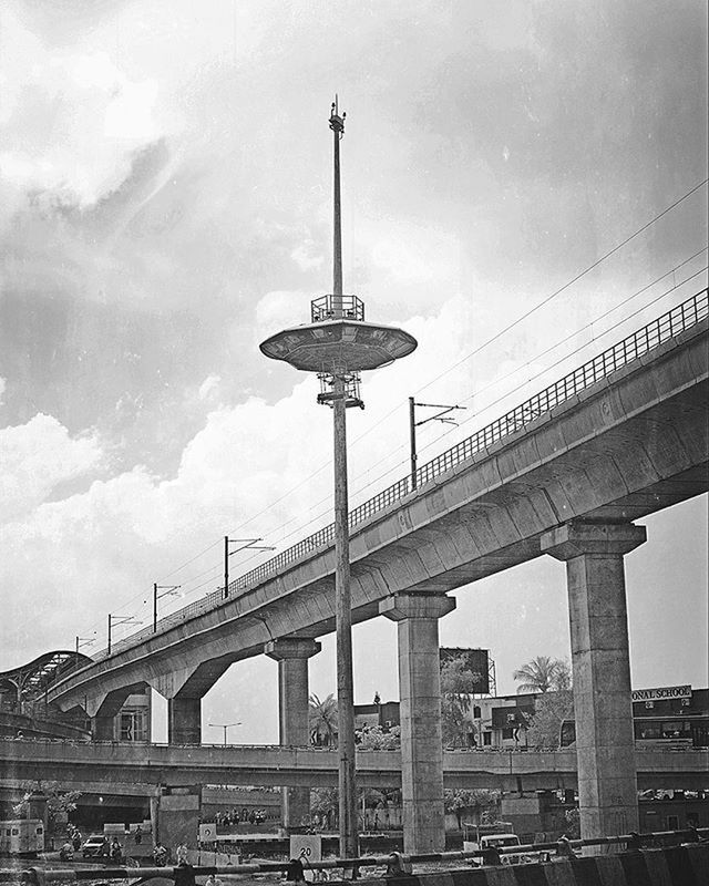 architecture, built structure, low angle view, connection, sky, bridge - man made structure, building exterior, street light, engineering, cloud - sky, city, lighting equipment, bridge, cloudy, day, cloud, railing, transportation, outdoors, architectural column