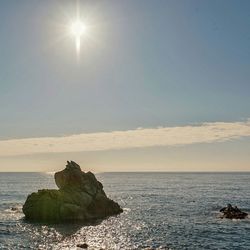 Scenic view of sea against sky at sunset