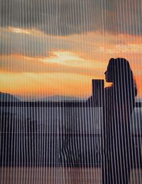 Full frame shot of metal fence during sunset