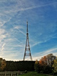 Low angle view of communications tower against sky