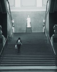 Low angle view of people walking on staircase