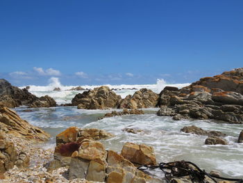 Scenic view of rocks and sea against sky