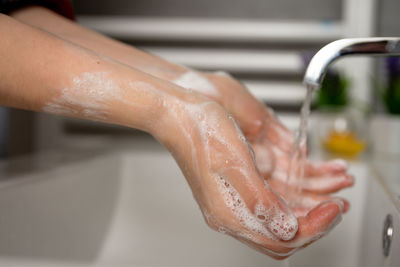 Midsection of woman in bathroom at home