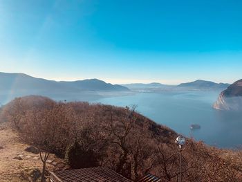 Scenic view of mountains against blue sky