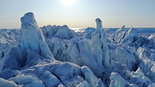 Scenic view of snowcapped landscape against sky during winter