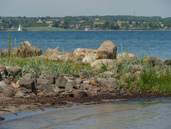 Rocks by sea against sky