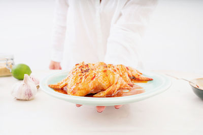 Close-up of person preparing food on table