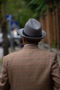 Rear view of man wearing hat outdoors