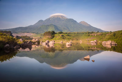 Scenic view of lake and mountains against sky