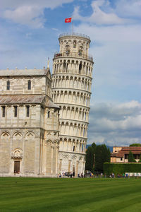 The monument of the leaning tower of pisa built in marble in piazza dei miracoli in tuscany