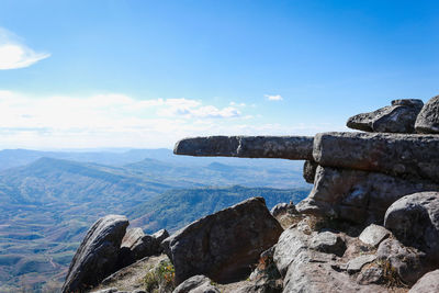 Scenic view of rocks and mountains against blue sky