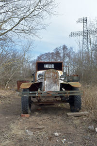 Abandoned truck on field against sky