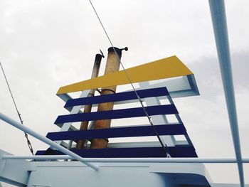 Low angle view of smoke stack on ferry against sky