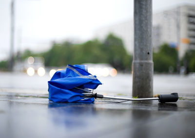 A broken umbrella is on the street