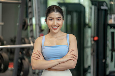 Portrait of young woman standing in gym