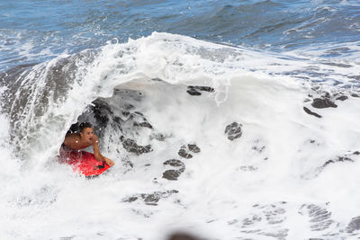 High angle view of boy in sea