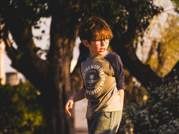 Rear view of boy standing outdoors