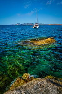 Sailboat sailing on sea against sky