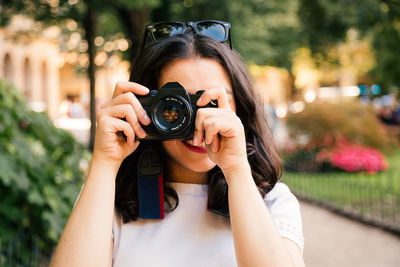 Portrait of woman photographing