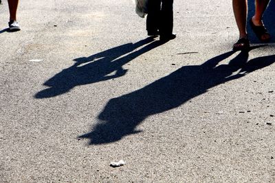 Low section of people walking on street