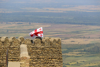 Flag on landscape against sky