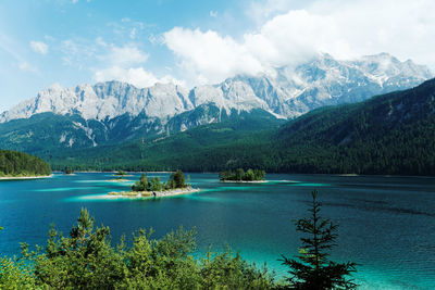 Scenic view of lake and mountains against sky